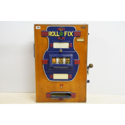 166 - Early 20th century Rollofix one armed bandit, penny play machine with three reels, coin entry, hinge... 