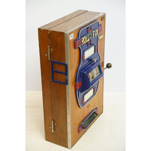 166 - Early 20th century Rollofix one armed bandit, penny play machine with three reels, coin entry, hinge... 