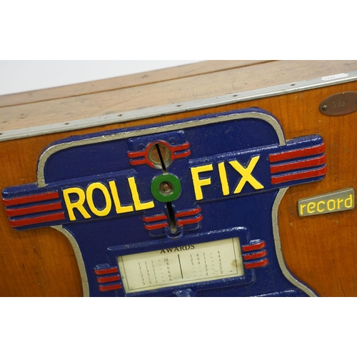 166 - Early 20th century Rollofix one armed bandit, penny play machine with three reels, coin entry, hinge... 