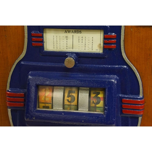 166 - Early 20th century Rollofix one armed bandit, penny play machine with three reels, coin entry, hinge... 