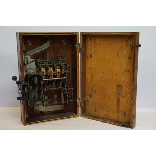 166 - Early 20th century Rollofix one armed bandit, penny play machine with three reels, coin entry, hinge... 