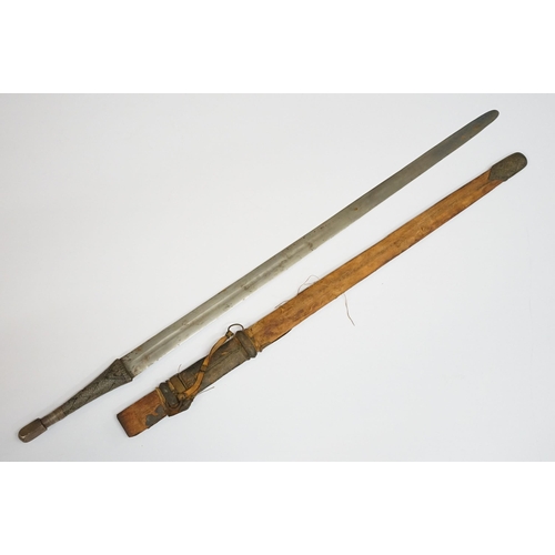 269 - An antique Omani Kattara sword, complete with wooden scabbard.