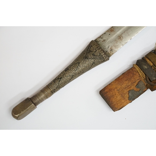 269 - An antique Omani Kattara sword, complete with wooden scabbard.