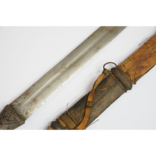 269 - An antique Omani Kattara sword, complete with wooden scabbard.