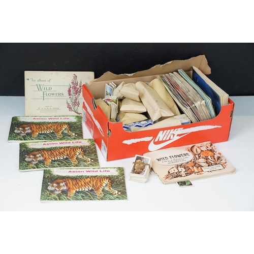 272 - A collection of cigarette and tea cards within albums and together with loose examples to include Br... 