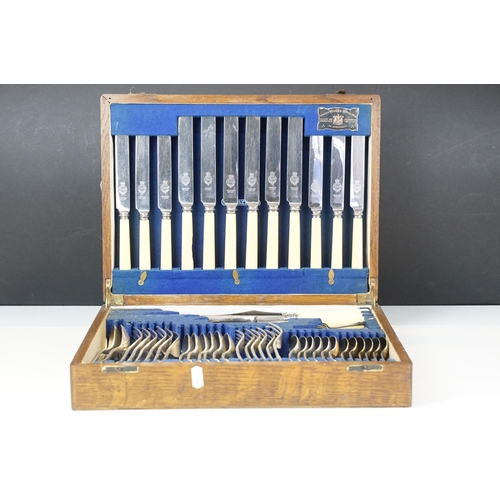 292 - An oak cutlery canteen complete with silver plated cutlery by Viners.