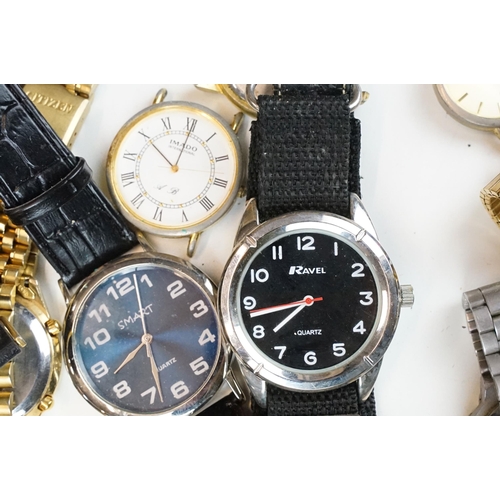 302 - A large collection of mixed wristwatches contained within a large porcelain bowl.