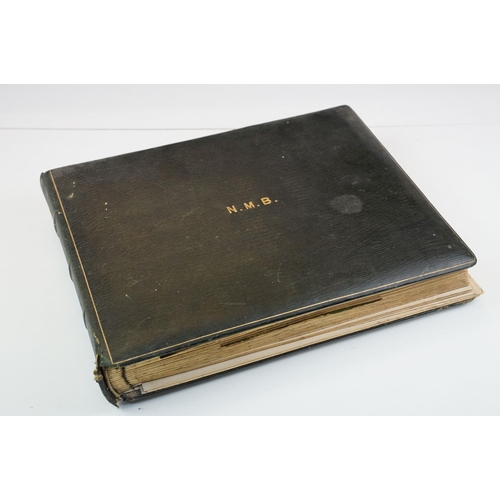 310 - Early 20th century black leather album containing approximately 250 black and white photographs and ... 