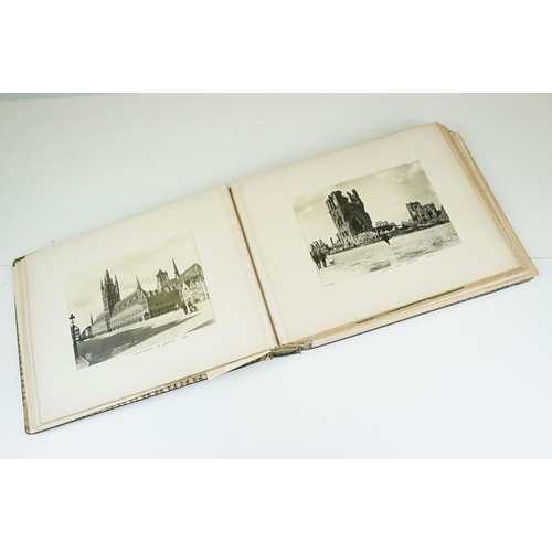 310 - Early 20th century black leather album containing approximately 250 black and white photographs and ... 