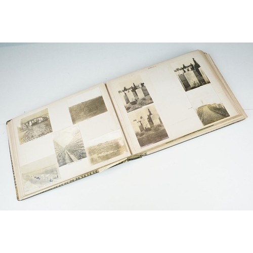 310 - Early 20th century black leather album containing approximately 250 black and white photographs and ... 