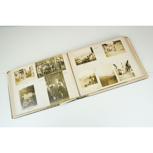 310 - Early 20th century black leather album containing approximately 250 black and white photographs and ... 