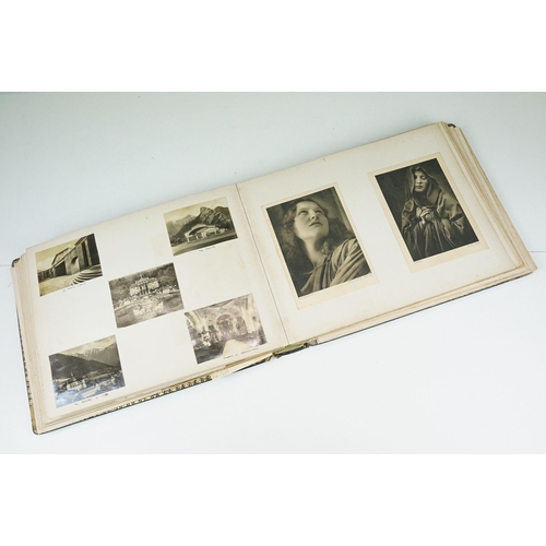 310 - Early 20th century black leather album containing approximately 250 black and white photographs and ... 