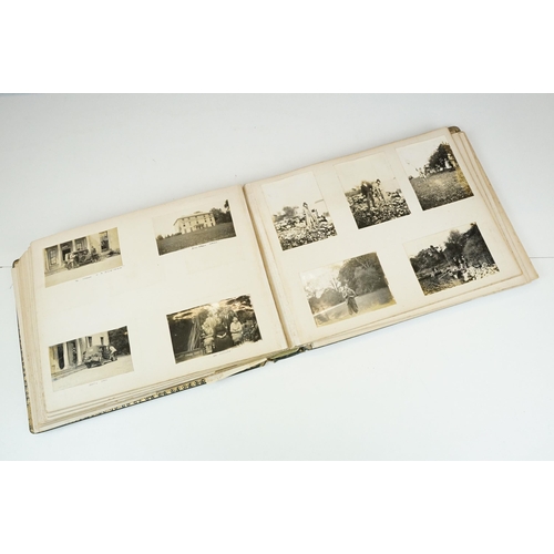 310 - Early 20th century black leather album containing approximately 250 black and white photographs and ... 