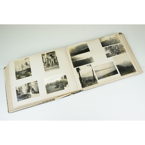 310 - Early 20th century black leather album containing approximately 250 black and white photographs and ... 