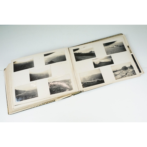 310 - Early 20th century black leather album containing approximately 250 black and white photographs and ... 