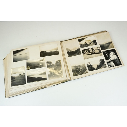 310 - Early 20th century black leather album containing approximately 250 black and white photographs and ... 