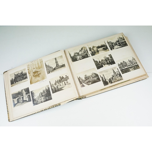 310 - Early 20th century black leather album containing approximately 250 black and white photographs and ... 