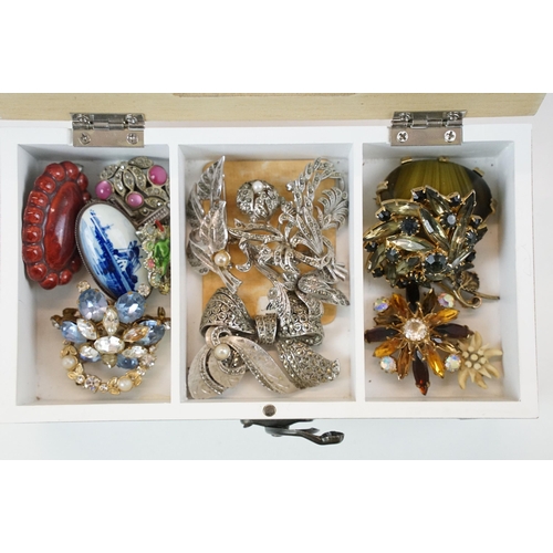 320 - A collection of vintage brooches to include gold tone examples within a wooden box.