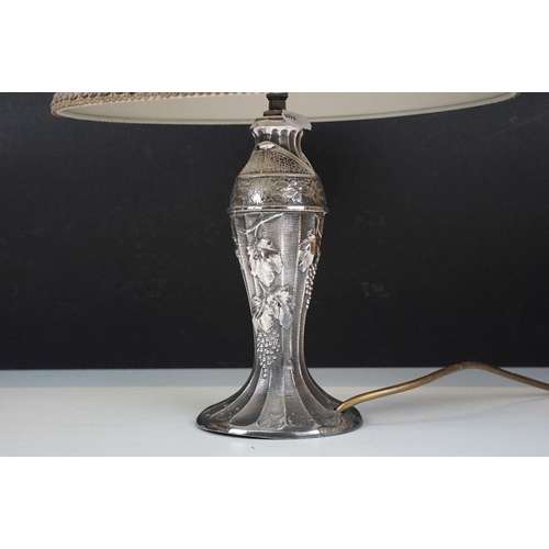 328 - Art Nouveau white metal lamp bases one with grape and vine relief decoration H 21cm together with a ... 