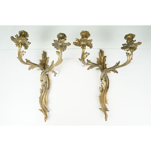 372 - Pair of Rococo style brass wall candle sconces with twin branches and interweaving design, approx. H... 