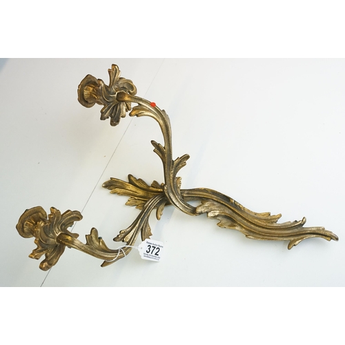 372 - Pair of Rococo style brass wall candle sconces with twin branches and interweaving design, approx. H... 