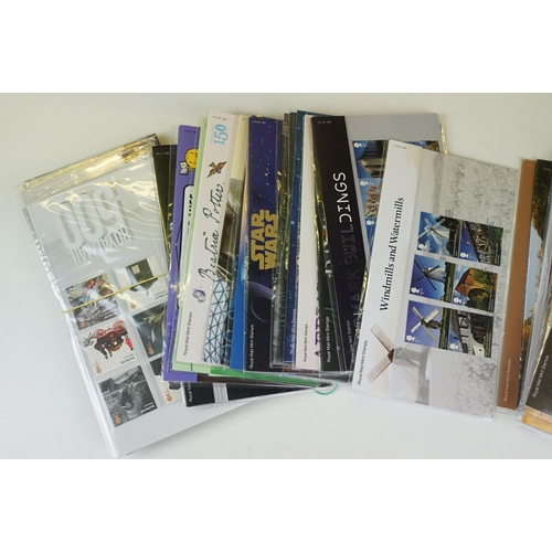 342 - A large collection of British Royal Mail presentation packs within three albums together with loose ... 