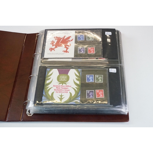 346 - A large collection of British Royal Mail presentation packs within three albums together with loose ... 