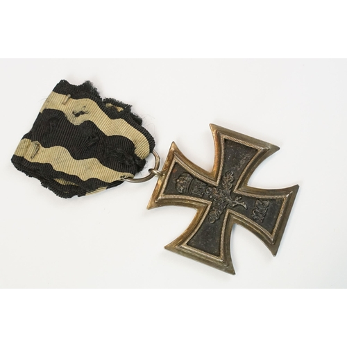 266 - A World War One German full size Iron Cross 2nd class medal with original ribbon.