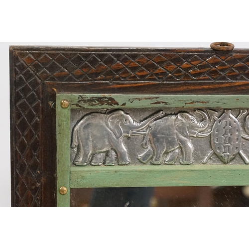 557 - Vintage carved wooden wall mirror with white metal plaques depicting elephants and hippos, 53 x 36.5... 