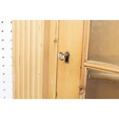 559 - 20th century pine corner cupboard, with breakfront pediment, astragal glazed door opening to reveal ... 