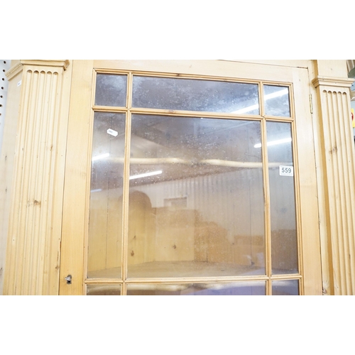 559 - 20th century pine corner cupboard, with breakfront pediment, astragal glazed door opening to reveal ... 