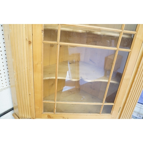 559 - 20th century pine corner cupboard, with breakfront pediment, astragal glazed door opening to reveal ... 