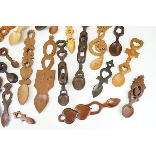 389 - A large collection of wooden Welsh love spoons of various sizes, mainly contemporary examples.