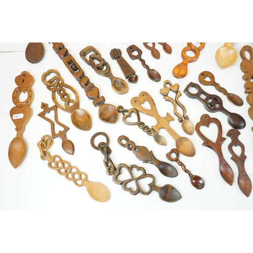 389 - A large collection of wooden Welsh love spoons of various sizes, mainly contemporary examples.