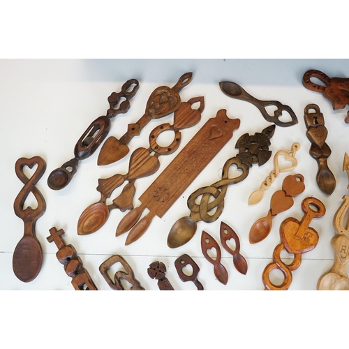 389 - A large collection of wooden Welsh love spoons of various sizes, mainly contemporary examples.