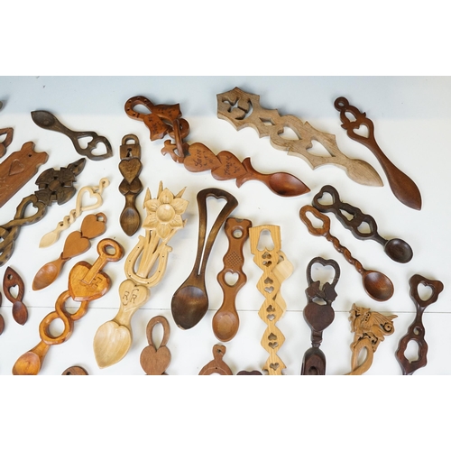 389 - A large collection of wooden Welsh love spoons of various sizes, mainly contemporary examples.