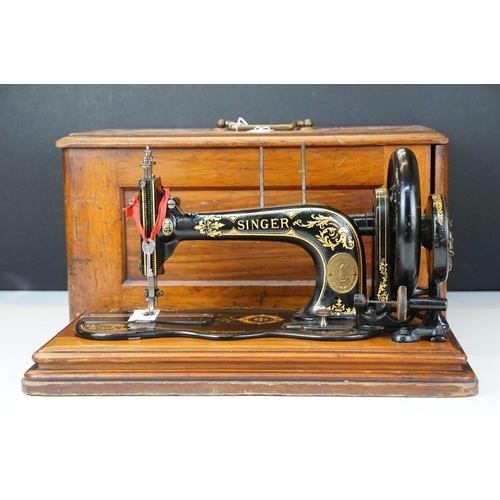 403 - Early 20th Century singer sewing machine set within wooden case together with a later Singer example... 