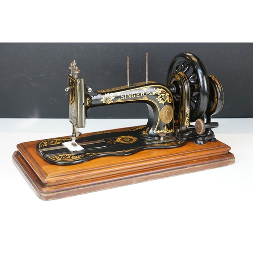 403 - Early 20th Century singer sewing machine set within wooden case together with a later Singer example... 