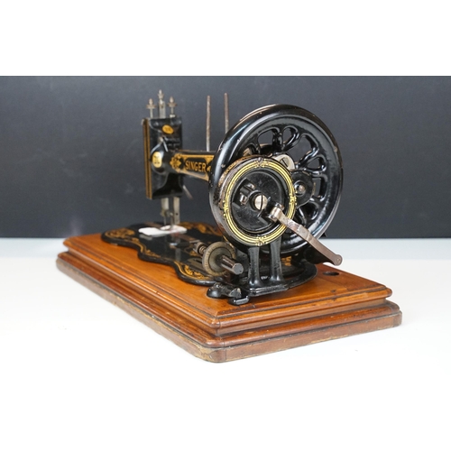 403 - Early 20th Century singer sewing machine set within wooden case together with a later Singer example... 