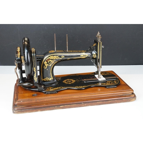 403 - Early 20th Century singer sewing machine set within wooden case together with a later Singer example... 