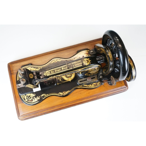 403 - Early 20th Century singer sewing machine set within wooden case together with a later Singer example... 