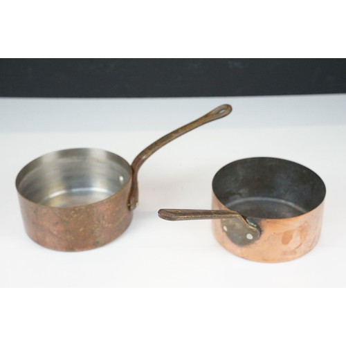 306 - A set of graduated copper saucepans together with three copper graduated pans.