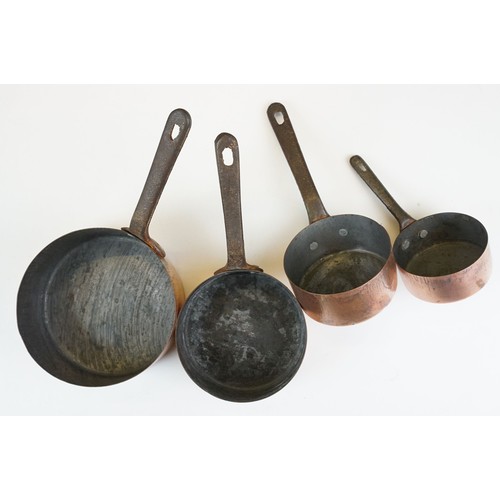 306 - A set of graduated copper saucepans together with three copper graduated pans.