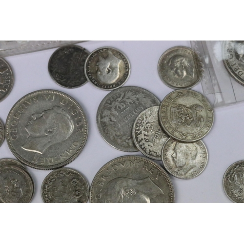 199 - A small collection of British pre decimal silver coins to include double florin, florins, shillings,... 