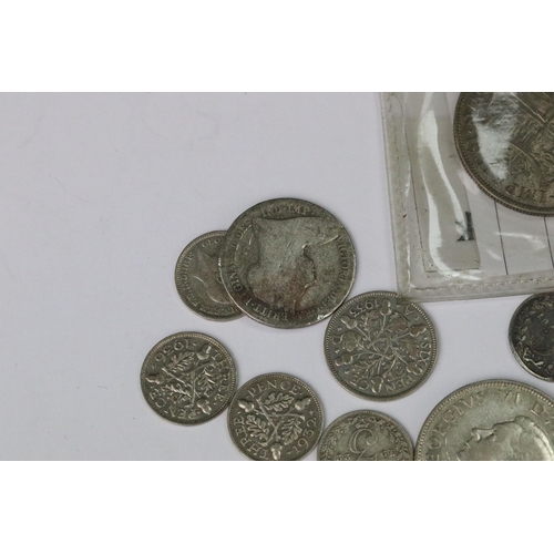 199 - A small collection of British pre decimal silver coins to include double florin, florins, shillings,... 