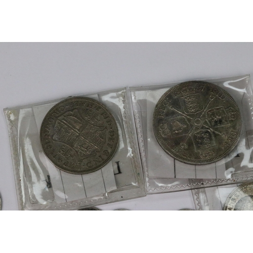 199 - A small collection of British pre decimal silver coins to include double florin, florins, shillings,... 