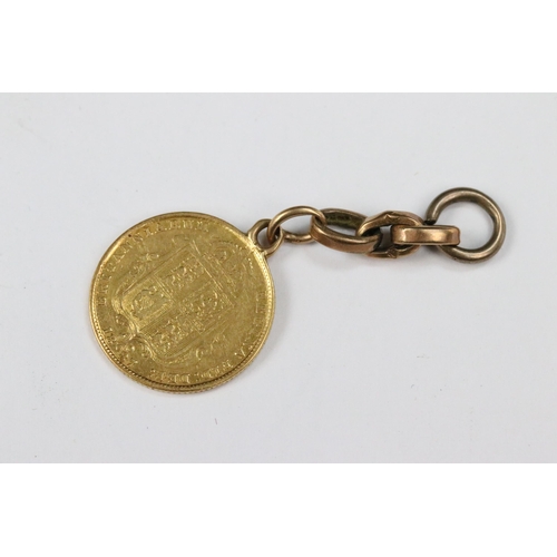 111 - A British Queen Victoria 1887 gold half sovereign coin mounted to small length of 9ct gold chain.