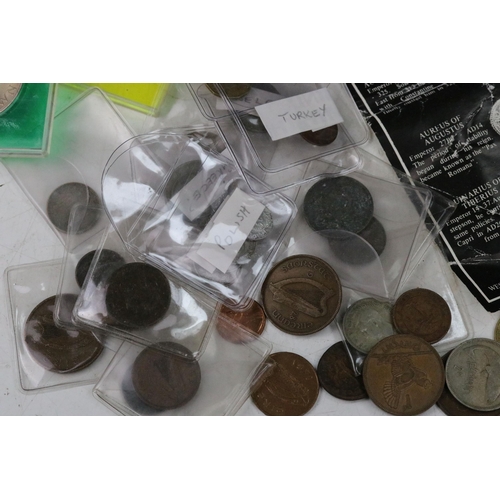 130 - A collection of mixed world coins to include commemorative crowns and early silver examples together... 