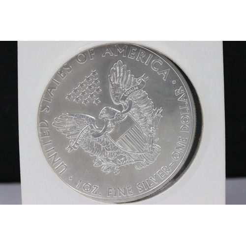 145 - A collection of three American silver dollars to include 1885, 1926 and 2014 examples.