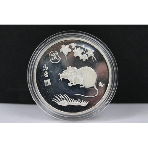 148 - A collection of twelve Chinese new year collectors coins encapsulated and contained within a two tie... 